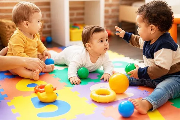 Baby exploring a sensory activity in the infant child care program at Kinder Grove